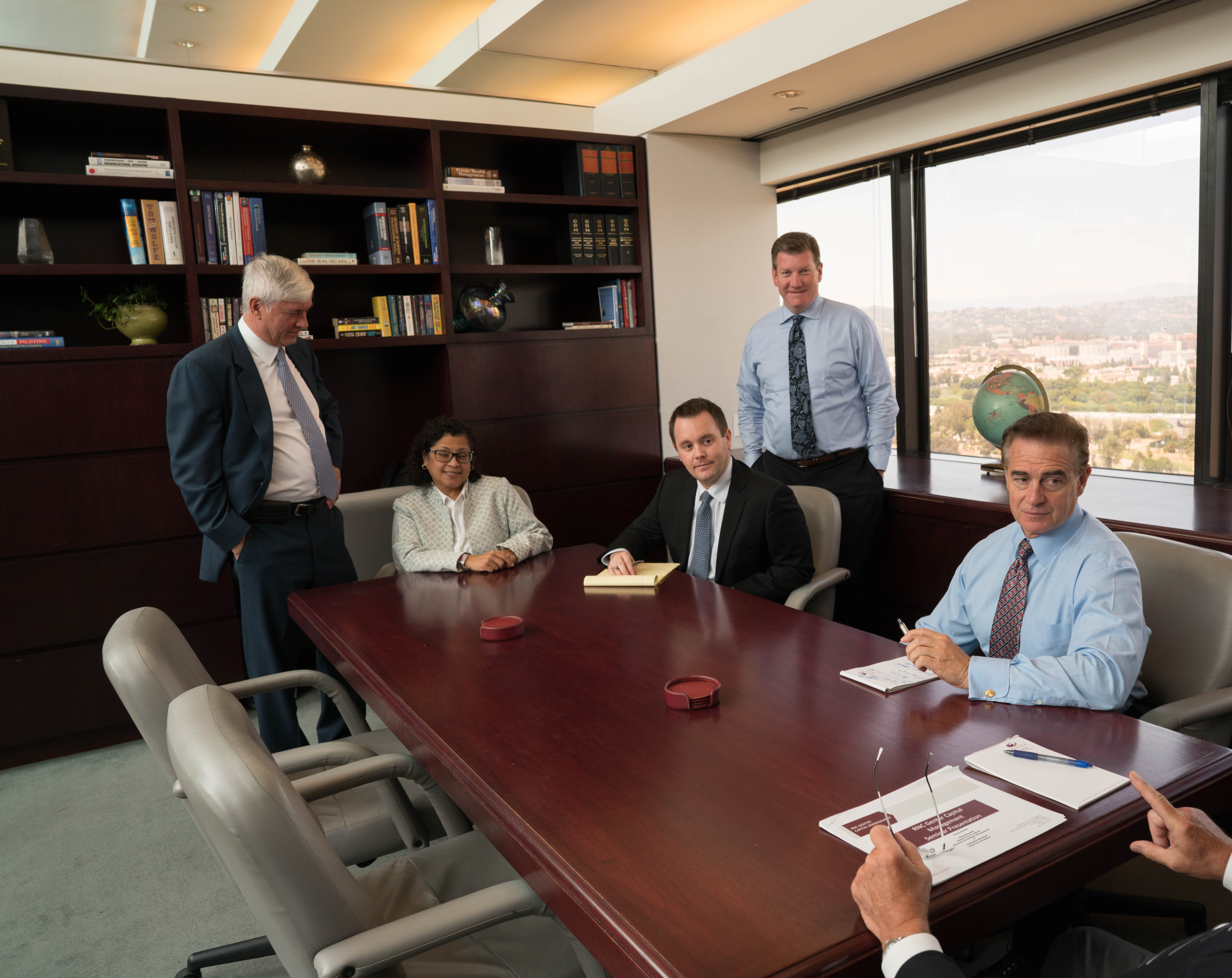 Genter Advisors investment team reviewing markets on Bloomberg terminals